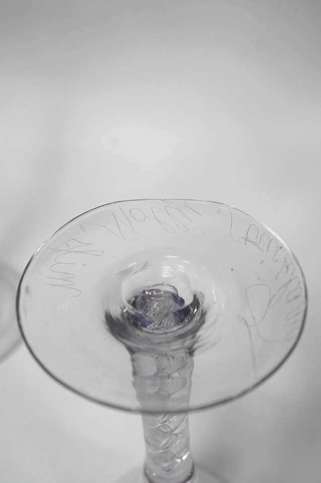 Two air twist stem drawn trumpet wine glasses, c.1750, the smaller example diamond point engraved ‘Miss Molly Strickland’, largest 19.2cm high. Condition - large wine glass - good, smaller glass - ground off foot and two